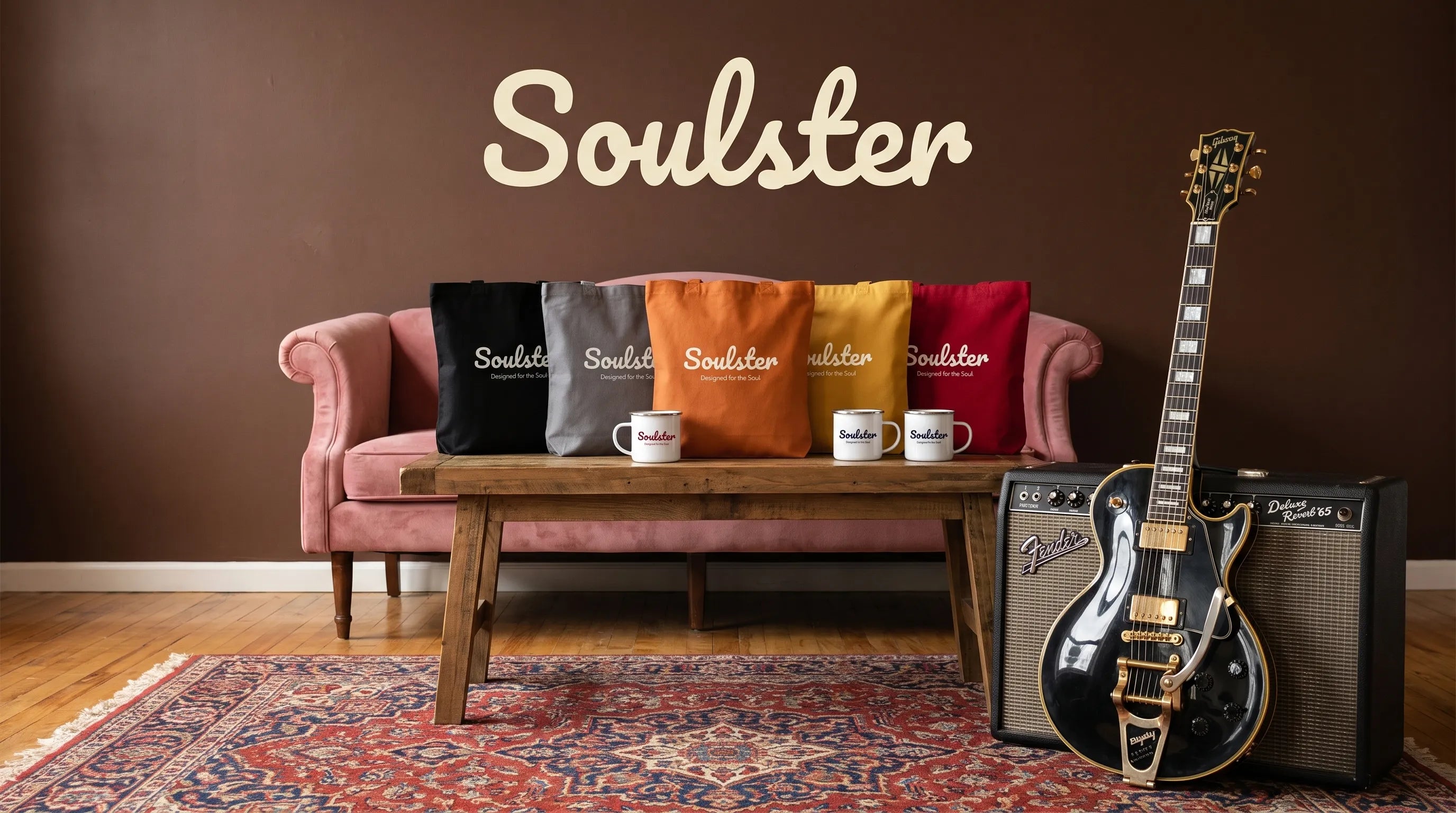 A styled interior scene with a pink sofa, wooden coffee table, patterned rug, electric guitar, and amplifier in a room with a brown wall. The word Soulster appears prominently on the pillows, mugs, and wall, indicating the visible brand.